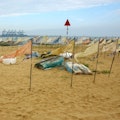 Pennants depicting each mile of coastline displayed as an installation on the beach